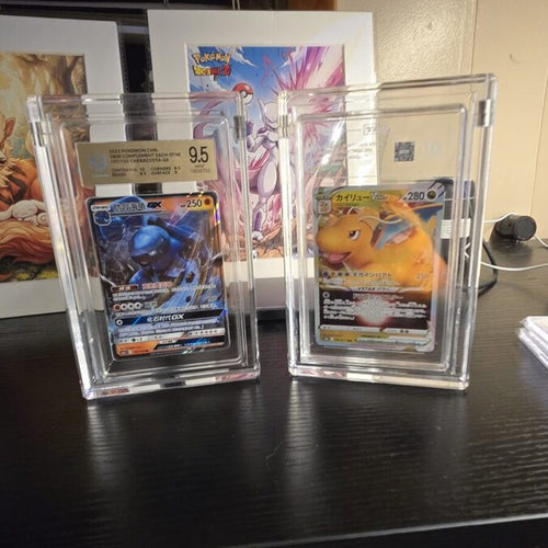 A graded Carracosta GX and Dragonite VSTAR standing in Podium acrylic display cases