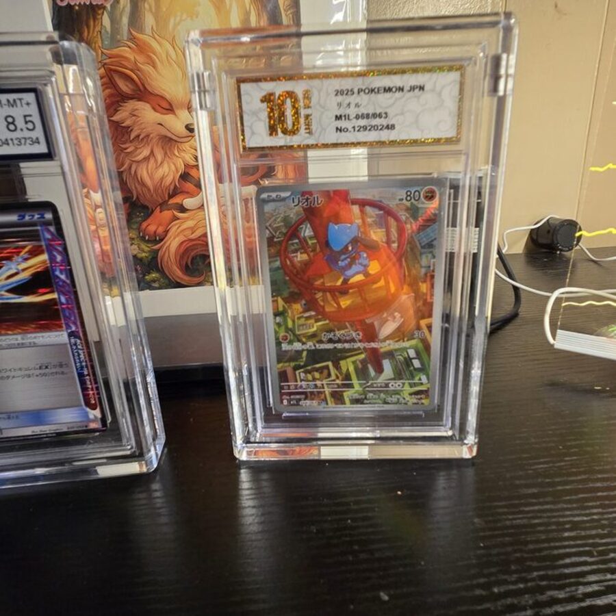 A Gem Mint 10 Riolu and a 1st edition Crystal Edge trainer card in Podium display cases